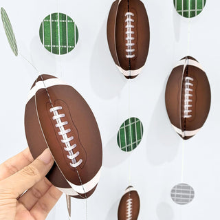 Brown football garland ornaments with white laces and green plaid circle accents