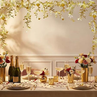 Gold leaf vine garland canopy with dangling leaf vines and heart-shaped details over table.