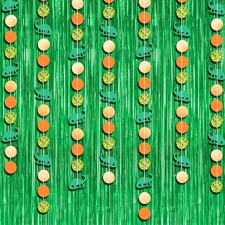 Green glitter fringe curtain with dinosaur-themed hanging garland strands