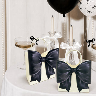 Cream gift bags with glossy dark bow ribbons and satin handles on display