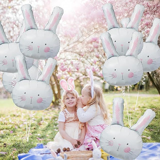 Light blue and white bunny head foil balloons with pink ear tips and faces