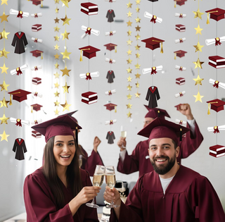 Graduation garland backdrop with burgundy caps, black gowns, gold stars, and diploma scrolls