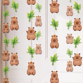 Hanging capybara garland with tan capybara figures and green leaf accents along strings