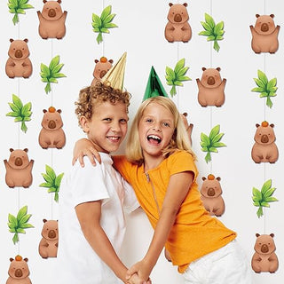 Hanging capybara party garland with tan capybara figures and green leaf decorations overhead