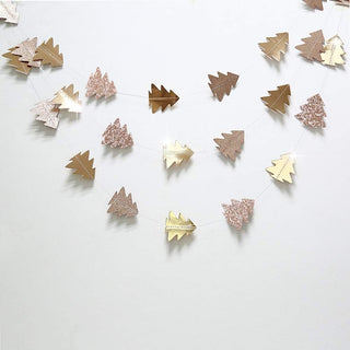 Flat lay of hanging tree garland with small glitter pine cutouts in mixed golds
