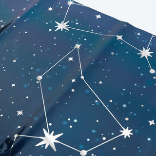 Close-up blue constellation tablecloth fabric with stars, lines, and geometric dots