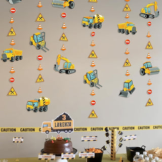 Construction truck garland pattern featuring yellow trucks, cones, and caution triangle icons