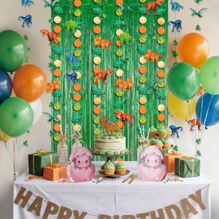 Green glitter fringe curtain backdrop with dinosaur-themed hanging garland and balloons