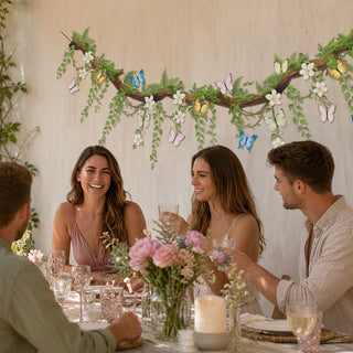 Floral butterfly wall banner garland with white flowers and butterfly motifs above guests