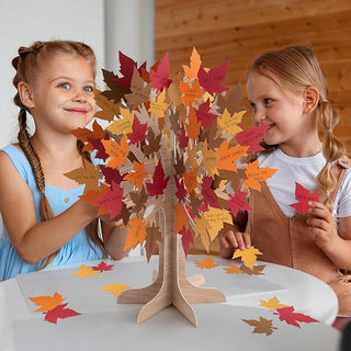 3D autumn leaf tree centerpiece on a wooden stand with layered red, orange, and tan leaves