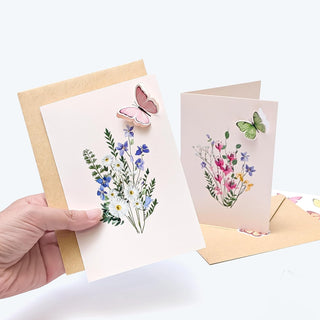 Floral butterfly greeting cards held with kraft envelopes, flower and butterfly artwork