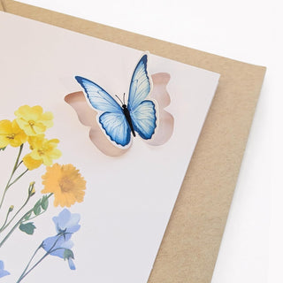 Floral butterfly greeting card close-up with blue butterfly on kraft envelope