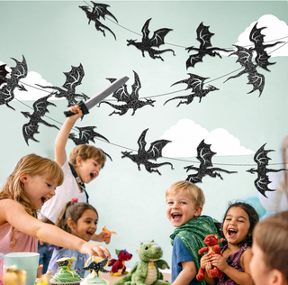 Black glitter dragon wall banner with dragons cutout silhouettes, shown hanging indoors