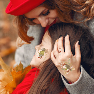 Temporary forest animal tattoos on hands and sleeves, showing hedgehog and pine