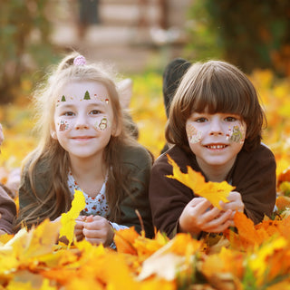 Temporary forest animal face tattoos on two children with pine and woodland designs