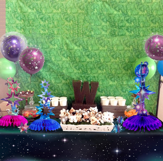 Holographic star tabletop centerpieces with blue and purple star toppers and tulle skirts