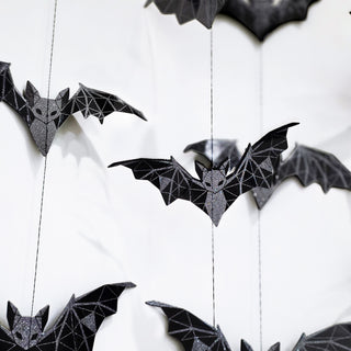 Black geometric glitter bat garland, close-up of hanging bat decorations