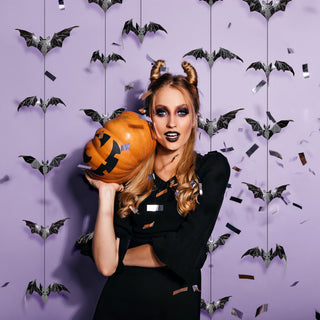 Black geometric glitter bat garland with hanging strings, scattered bat cutouts