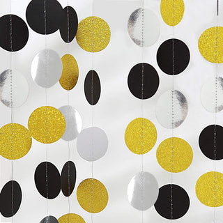 Graduation circle dots garland close-up of black, white, and gold glitter disks