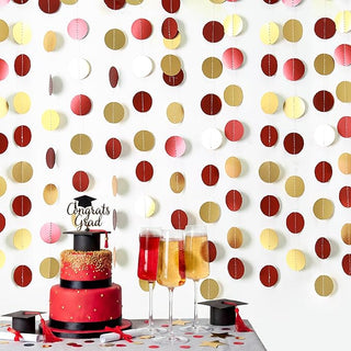 Circle dot party garland with stitched maroon, gold, red, and cream paper discs on string.