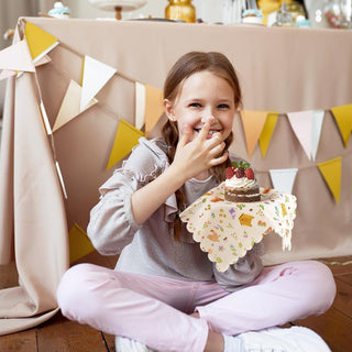 Decorative paper napkins with white, colorful garden print, child holding folded napkin.