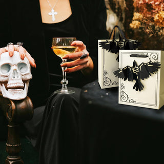 Halloween paper gift bags in cream with black crow cutout handles