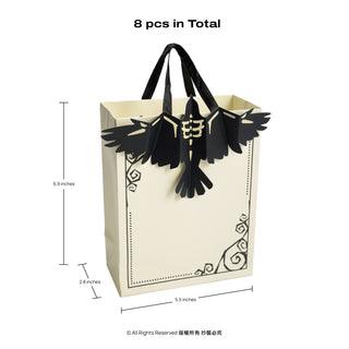 Cream paper gift bag with black handles and crow applique front decoration