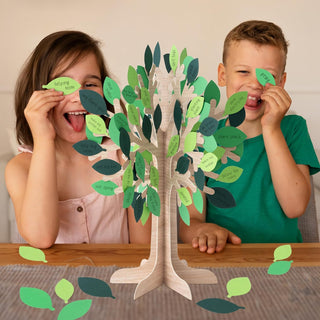 Table centerpiece tree with green paper leaves on a wooden base, in use