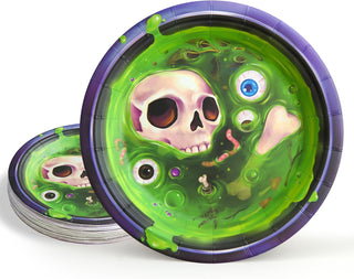 Round Halloween party plates with green cauldron-style skull graphic and purple rim