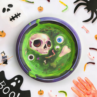 Round Halloween party plate with green skull graphic and purple rim