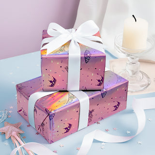 Stacked presents wrapped in pink iridescent paper with princess crown pattern