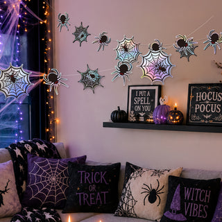 Holographic iridescent spiderweb banner with black spiders for spooky Halloween haunted house decor