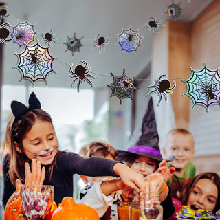 Iridescent Halloween spiderweb garland hanging as spooky party decorations for haunted house and horror themes