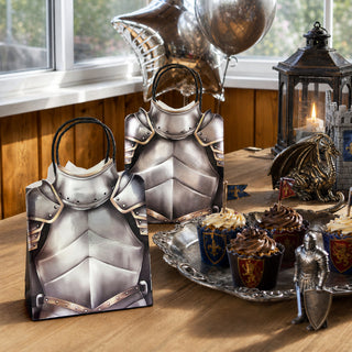 Knight armor party favor bags on table, silver armor design and black handles for parties