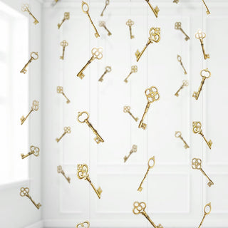 Gold key garland hanging vertically on window panels, repeating key charms