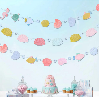 Seashell-themed banner garland with pastel pink, blue, and yellow shell cutouts