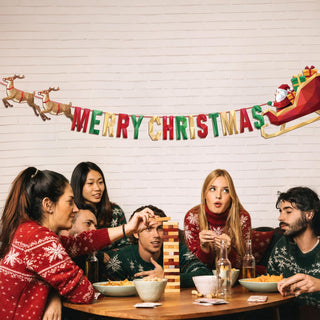 Christmas banner with “Merry Christmas” text, reindeer, and Santa sleigh