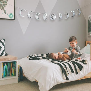 Silver moon phase wall banner with nine glittery moon shapes on string