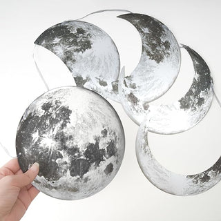 Set of silver moon ornaments with speckled glitter finish on hanging strings