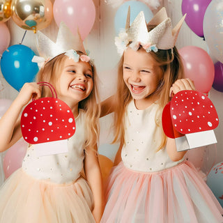 Red polka-dot mushroom gift bags with white dots and short handles, held by children