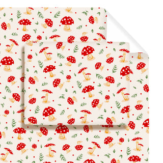 Close-up of mushroom-pattern wrapping paper, cream background with red toadstools
