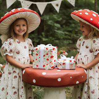 Wrapped gift boxes with mushroom-pattern wrapping paper, cream with red toadstools
