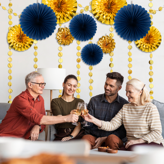 Gold and navy blue paper fan garland with pom-pom fans and hanging bead strands