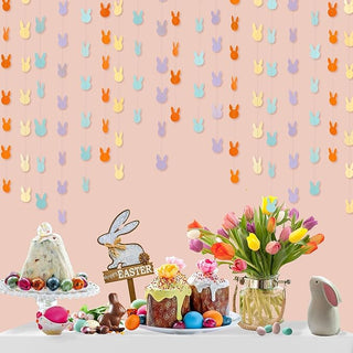 Pastel bunny garland hanging at an Easter dinner table, with pastel yellow, blue, purple and orange bunny cutouts
