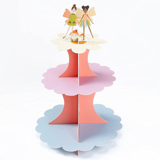 Pastel fairy cupcake stand with 3 tiers, scalloped plates, and two figurine cake toppers
