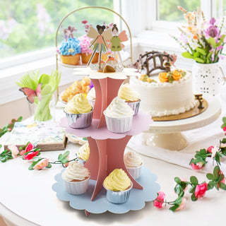 Pastel 3-tier cupcake stand with fairy figurines holding cupcakes and desserts
