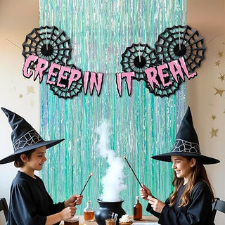 Teal fringe curtain with four black spider web decorations and 'GREEPIN IT REAL' banner