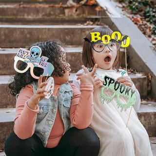Halloween photo booth props on sticks: Boo, skull, and witch-style speech cutouts