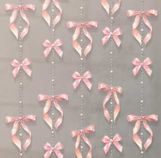 Pink satin bow garland with pearl bead strings and ribbon tails hanging vertically