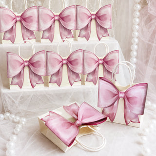 Rows of pink gift bags with matching oversized satin bows and handles